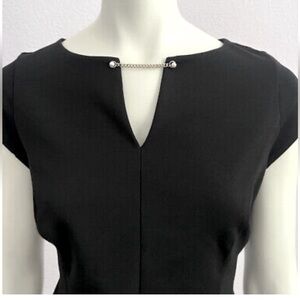 WHBM black tailored shirt with chain and pearl embellishment. Size 10.
